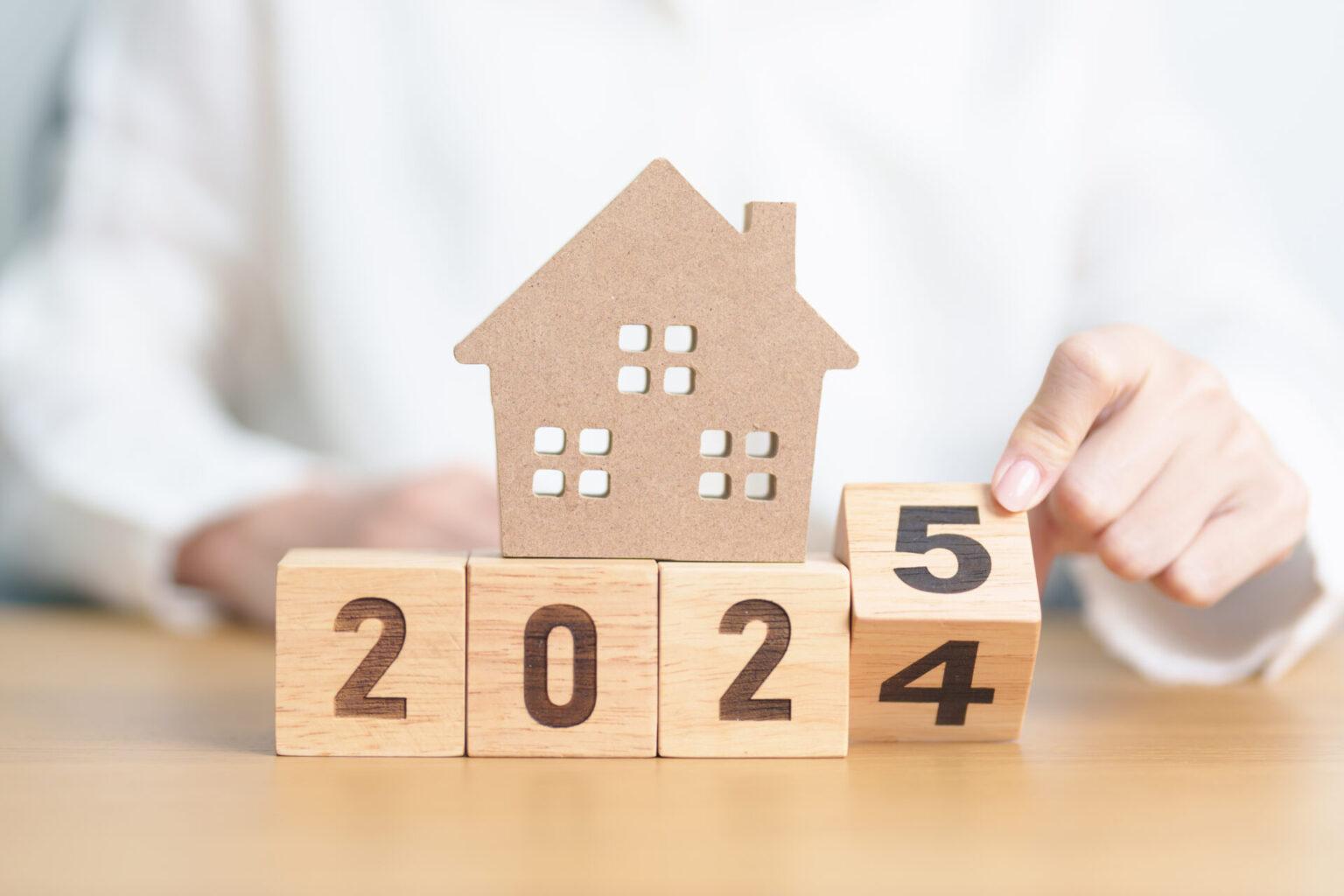 2024 end year to Happy New Year 2025 with house model. real estate, Home loan and mortgage, tax, investment, financial, savings and New Year Resolution concepts